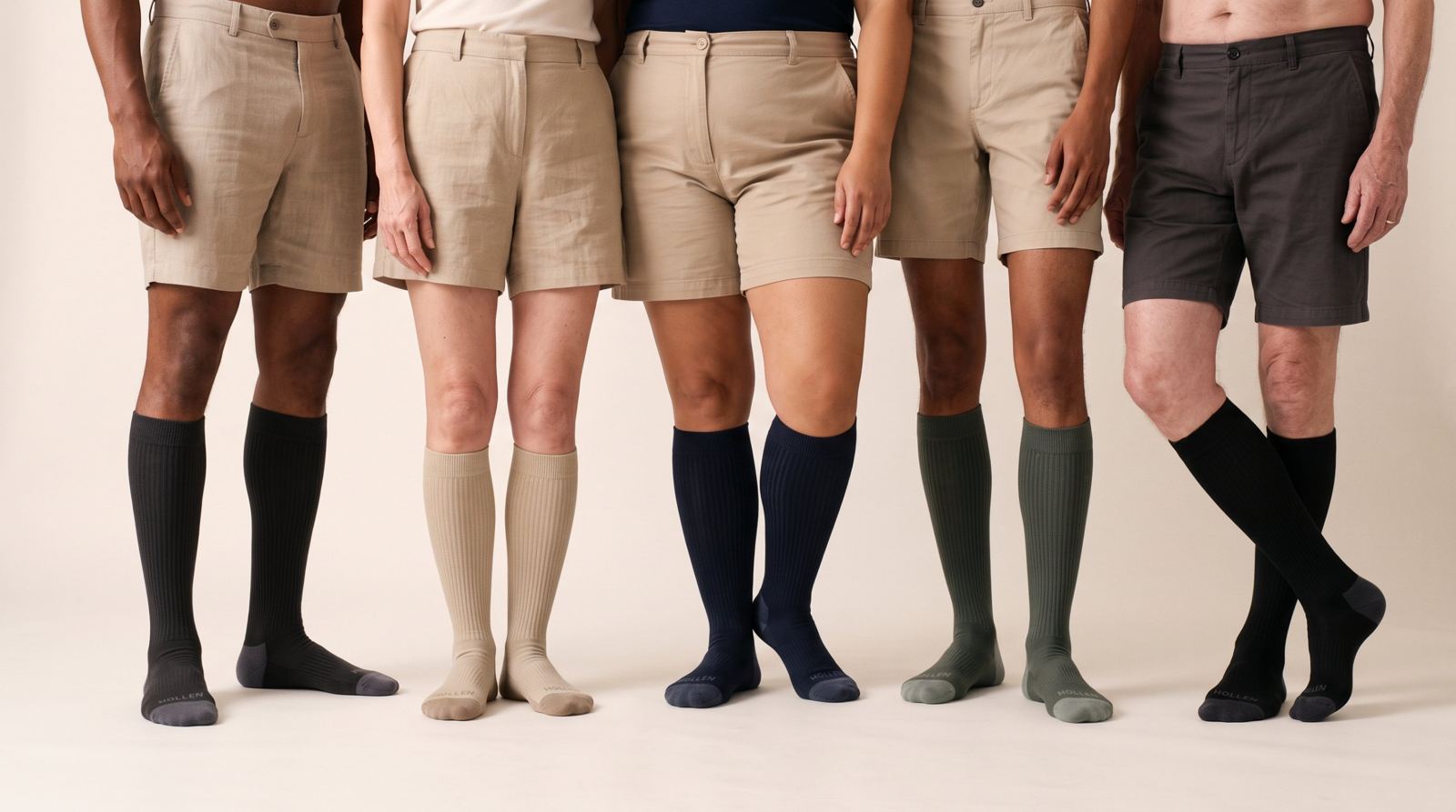 Five people in shorts standing in a row wearing the five Hollen colours